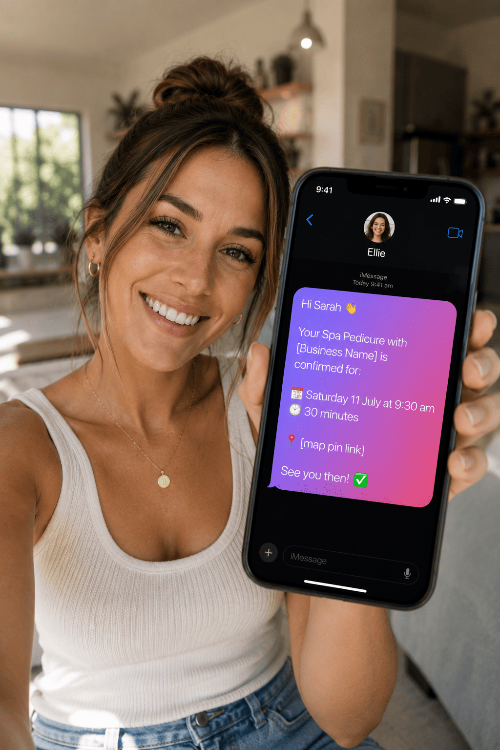 A customer holding up her phone showing a text booking confirmation from Ellie
