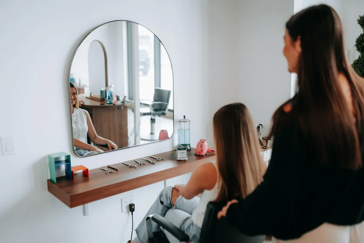 A stylist with a client mid-appointment in a hair salon